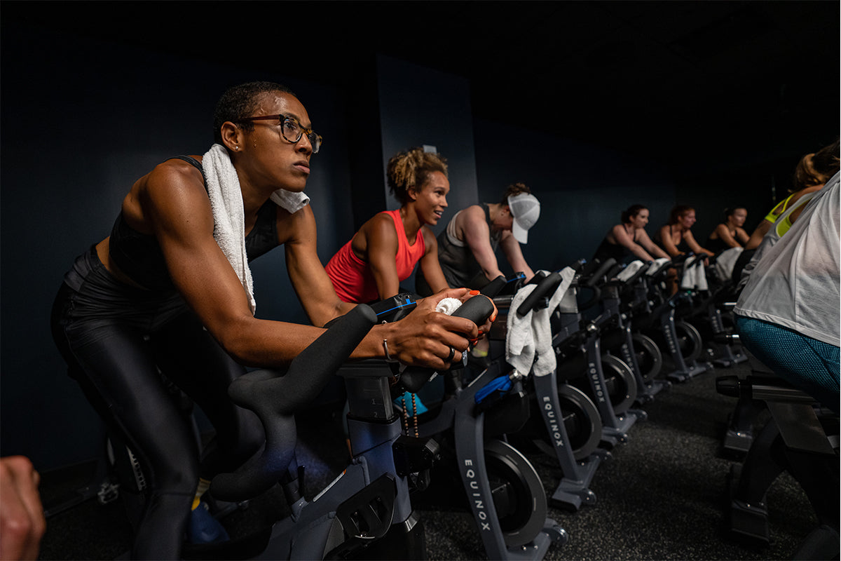Women working out during an indoor cycling spin class