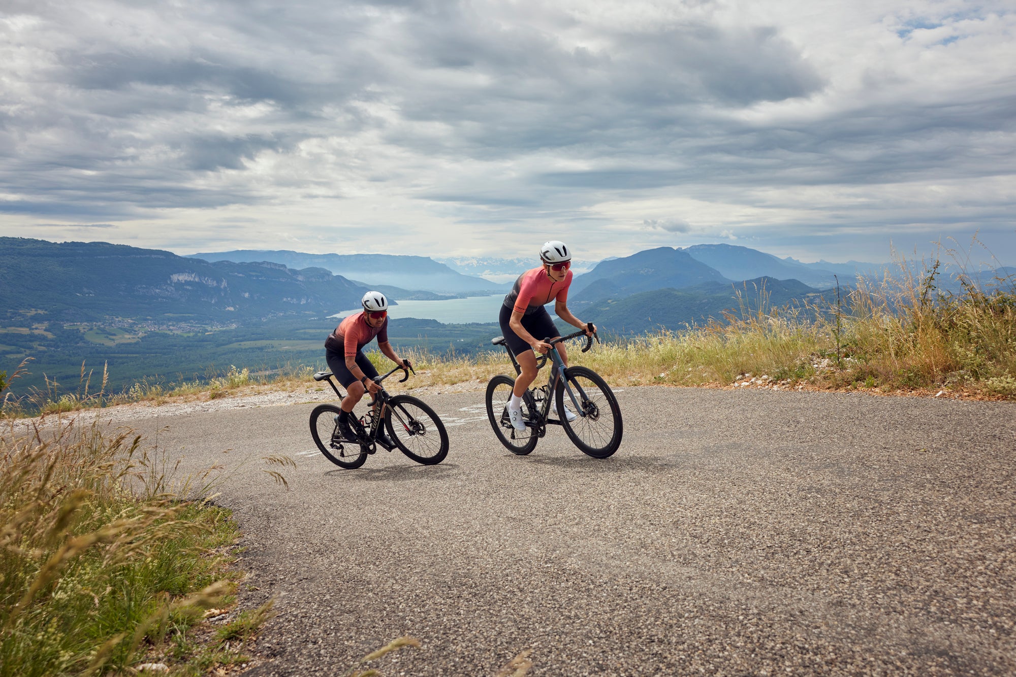 Two men riding SHIMANO equipped road bikes up a hill 